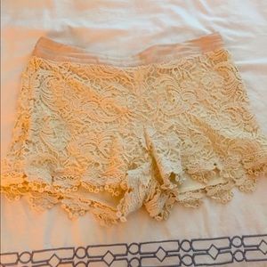 Cream colored shorts. Embroidery design